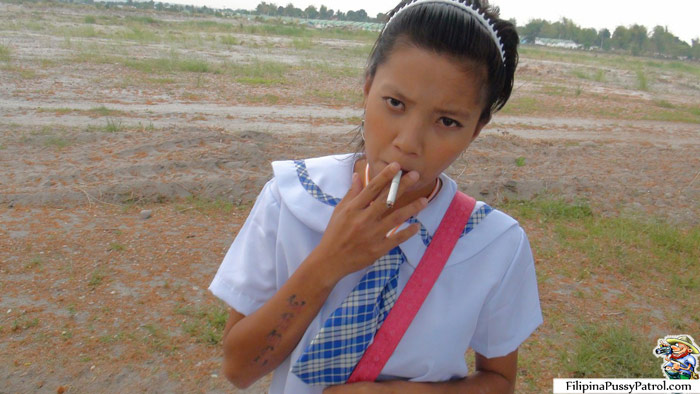 Smoking Filipina Schoolgirl In a Field